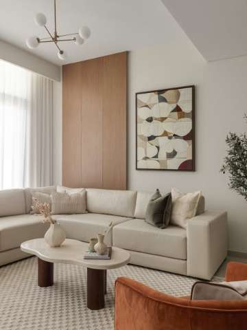 Living room interior with wood panelling and warm neutral furnishings, designed by Level Up Interior Design